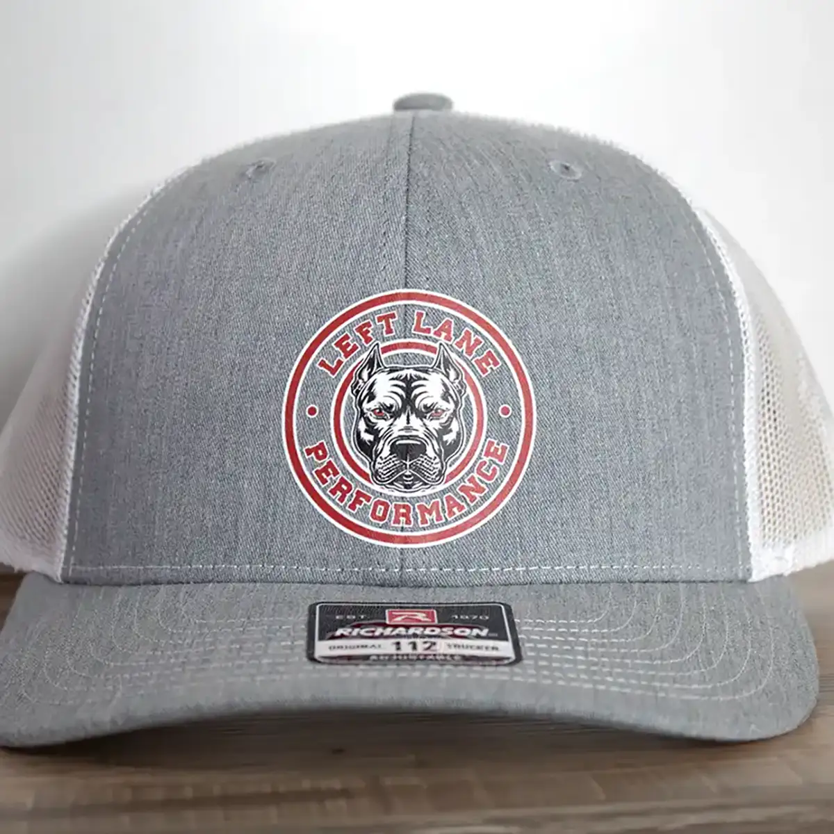 Left Lane Performance red design on Richardson 112 gray and white trucker style hat close view