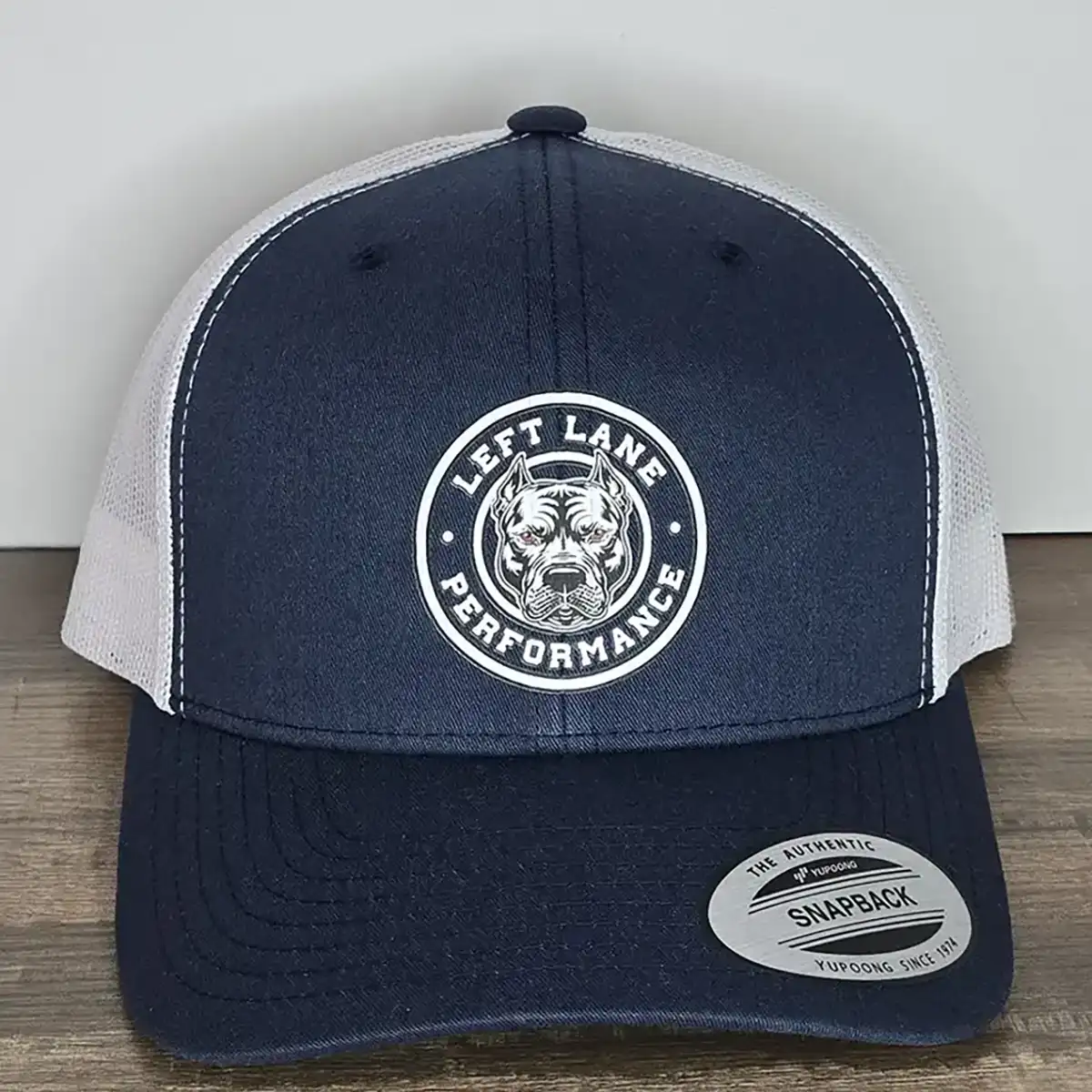 Left Lane Performance white design on Navy and White YP Classics trucker style hat close view