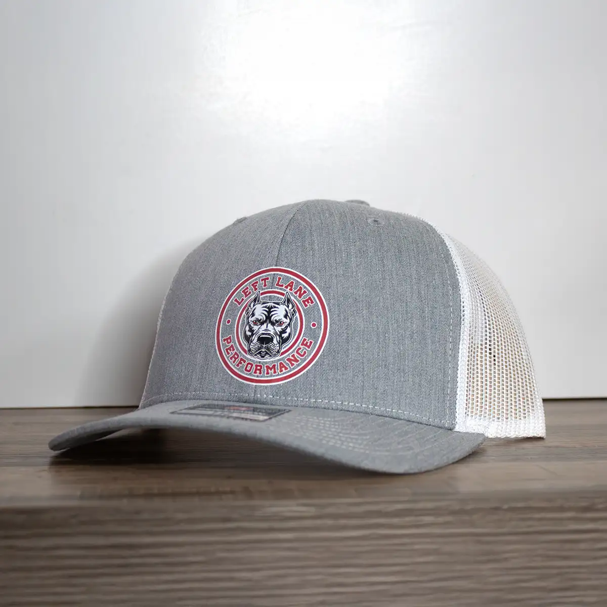 Left Lane Performance red design on Richardson 112 gray and white trucker style hat angle view