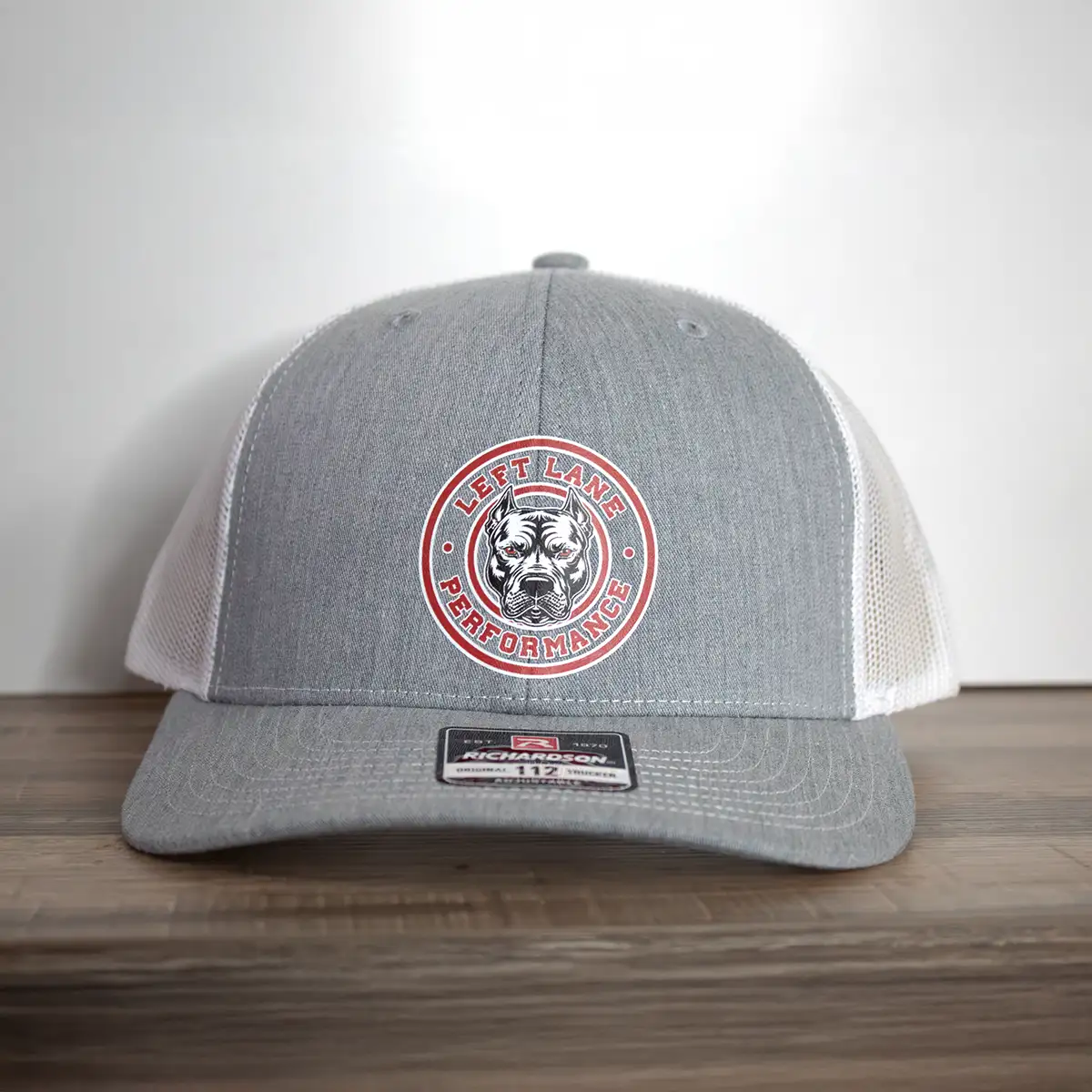 Left Lane Performance red design on Richardson 112 gray and white trucker style hat far view