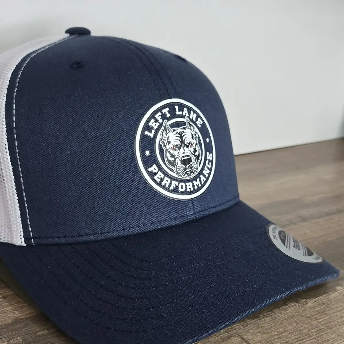 Left Lane Performance white design on Navy and White YP Classics trucker style hat angle