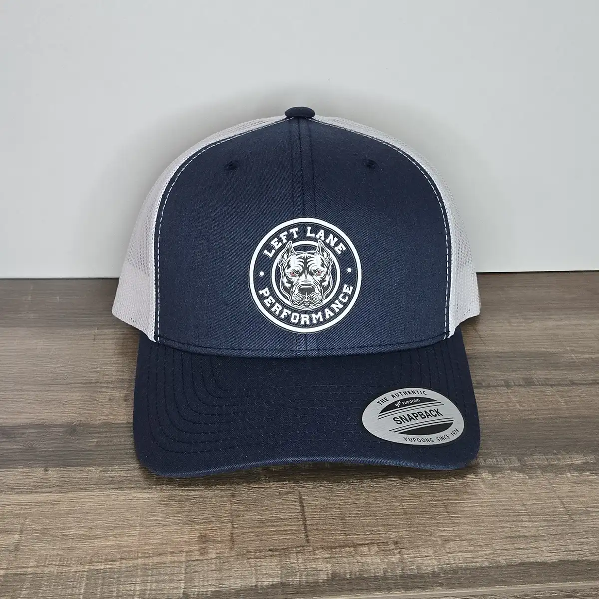 Left Lane Performance white design on Navy and White YP Classics trucker style hat to get noticed.