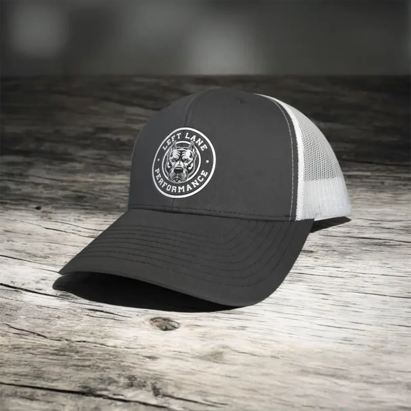 Left Lane Performance white design on charcoal and White YP Classics trucker style hat on counter